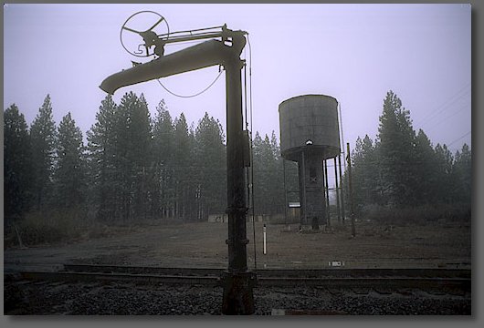 Water spout and water tank as rain turns to snow
