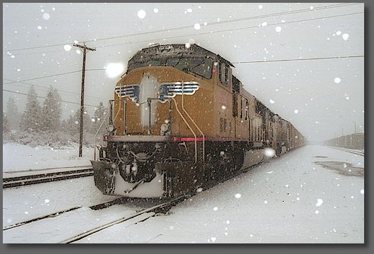 Northbound UP freight stops to work at the road crossing